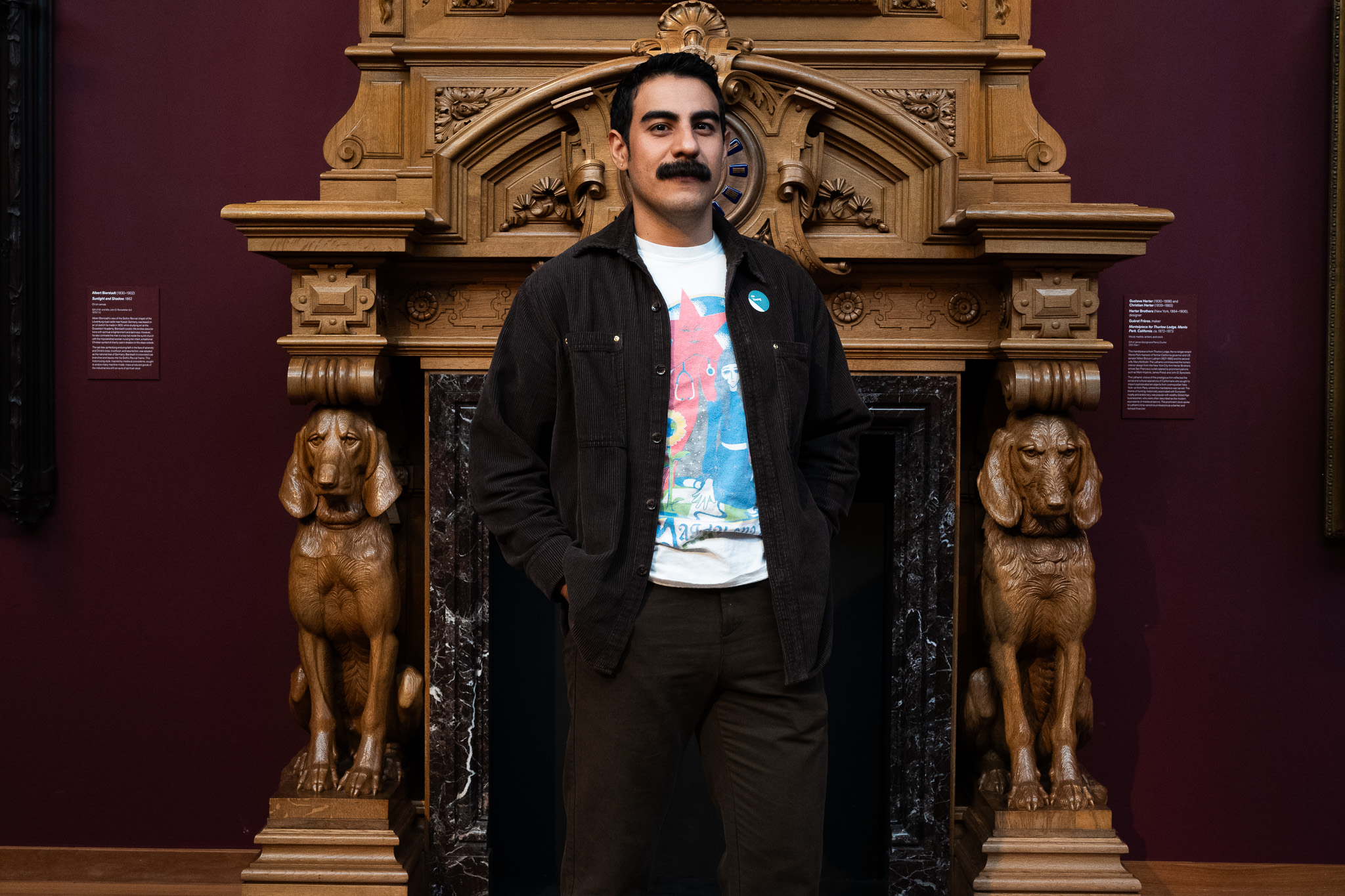 Myself against a mantle with two carved dogs